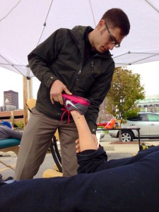 Dr. Chris LoRang treats a runner's sore calves with Active Release Technique (ART) after the Des Moines Marathon 2013.